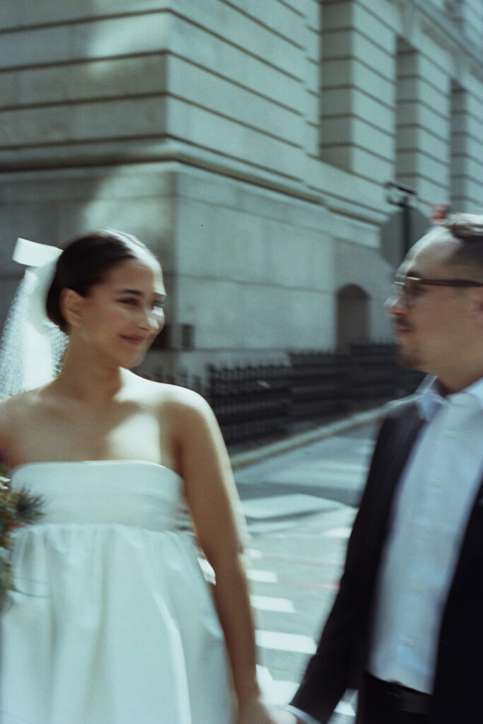 Wedding Photographer in New York, couple holding hands and looking at each other with a blurred stylized edit